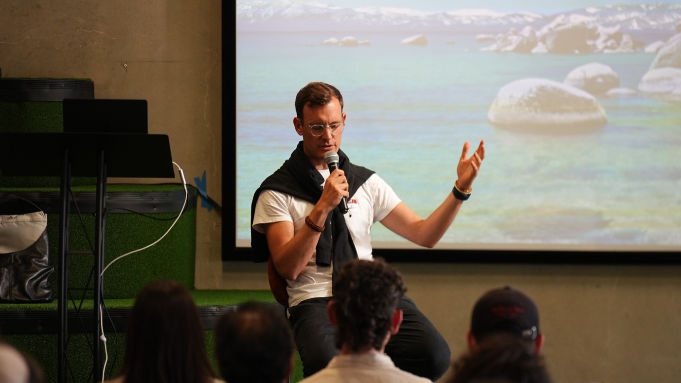 Jonatan Littke speaking on stage at a fireside chat